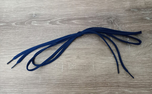 Blue shoelaces on a wooden table.