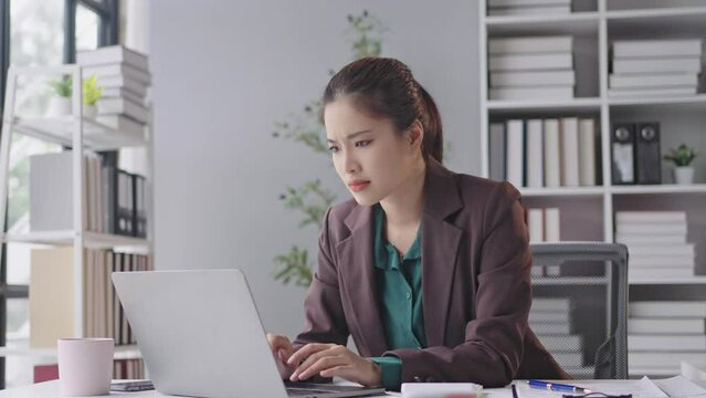 Frustrated businesswoman in modern office faces laptop issues, showing stress and emotions. Experience the challenges of technology in the workplace