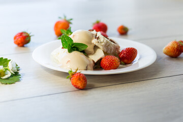 fresh organic cottage cheese with strawberries and ice cream in a plate on a wooden table