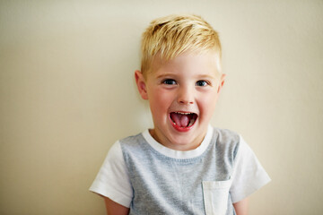 Happy, portrait and boy child in house on wall background for learning, development and morning games at home. Growth, face or excited kid in apartment for fun vacation, holiday or playing on weekend
