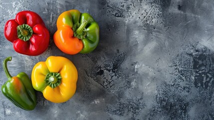 Colorful bell peppers on modern concrete surface Red orange yellow and green Flat lay top view