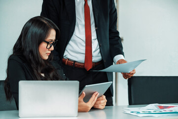 Senior executive manager and young businesswoman working in meeting room in the office. The woman...
