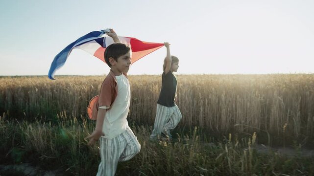 French little kids - patriot children runs with national flag on nature background at sunset. Celebration banner, holidays, France, reunion freedom day. - Powered by Adobe