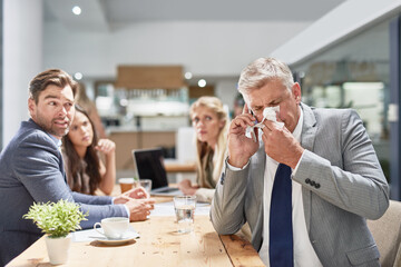 Phone call, meeting and sick businessman in office for allergies, hay fever and infection. Teamwork, corporate staff and person blow nose for cold, flu and sinusitis on smartphone for discussion