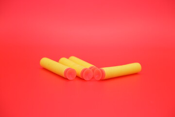 children's toy gun bullets isolated on red background
