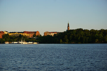 Scenic view of river by buildings against clear sky