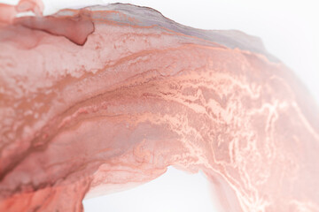 A close-up abstract image of a swirling ink pattern in delicate rose hues on a white background