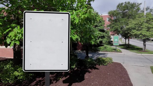 Dolly Shot of a blank sign in a generic American small town. Tracking points on sign for adding your message.	