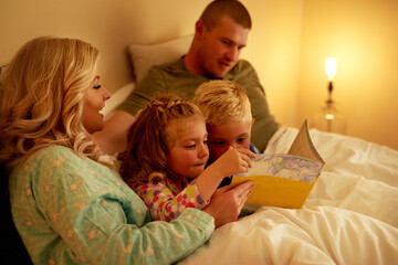Bed, parents and children with book for reading story, bonding together and connect with fantasy....
