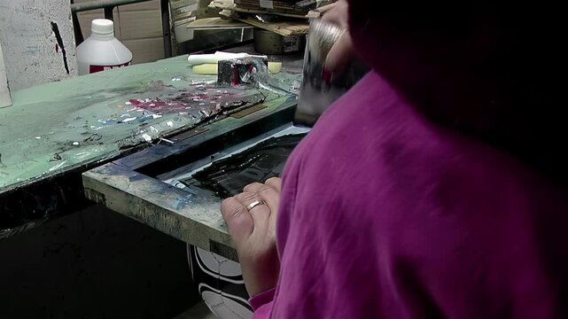 Printing Process in the Manufacturing of Soccer Balls: Female Worker Using Screen Printing Squeegee. Close Up. 4K Resolution.