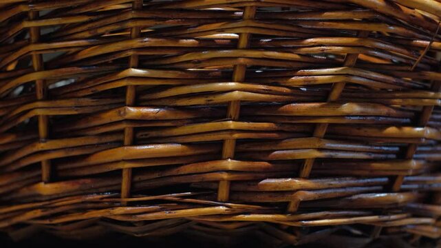 Texture of a wicker basket made of varnished rattan, close-up
