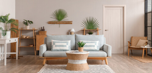 Interior of living room with grey sofa and table