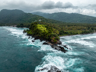 Aerial image of shore with waves and rocks on Lombok Indonesia