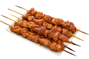 Close-up of grilled chicken skewers on a white plate isolated on a white background, transparent background.