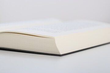 Close up of an open book on white table 