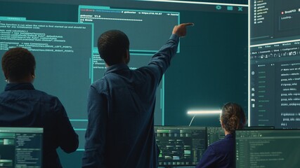 Cyber security team conducting cyber surveillance in a governmental control room. Experts group hacking activities, malware protection and data breach prevention in high tech agency. Camera A.