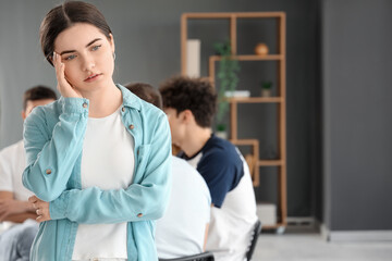 Fototapeta premium Sad young woman at group therapy session