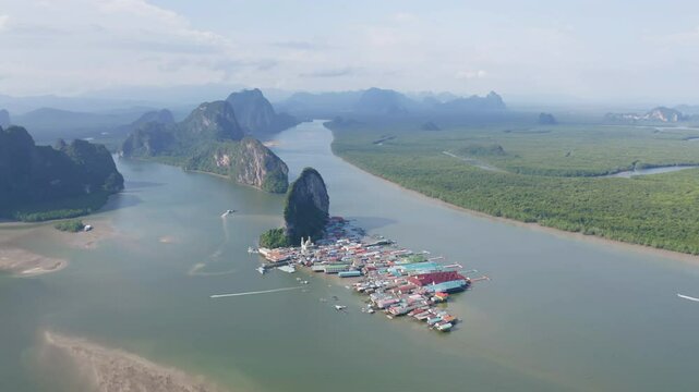 Aerial view of Koh Panyee, The Floating village urban city town houses, lake sea or river. Nature landscape fisheries and fishing tools at Pak Pha, Phang Nga, Thailand. Aquaculture farming