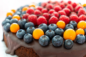 closeup shot of chocolate cake with fresh berries on top.