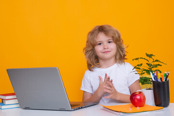 School child using laptop computer. Nerd school kid isolated on studio background. Clever child...