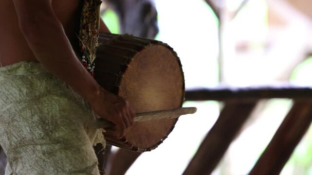 Ecuadorian Indigenous Wayuri Tribe Member Playing Drum During Traditional Dance in Amazon Rainforest