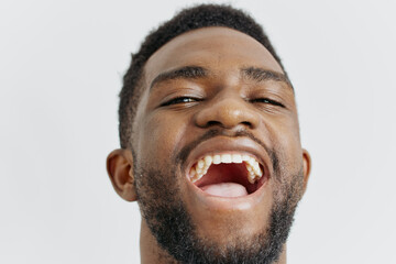 Young man expressing surprise with mouth open and tongue out, closeup of facial expression and tongue movement