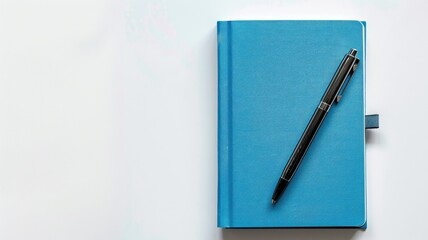 Blue notebook and pen on white surface