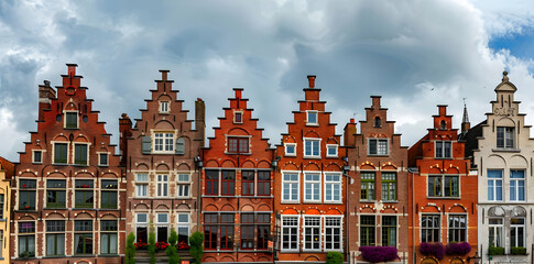 Obraz premium Row of Traditional Brick Buildings with Arched Windows in Bruges, Belgium Photo