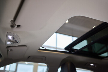 Motor vehicle with sunroof, rear view mirror, and hood