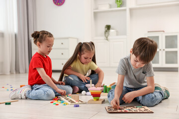 Naklejka premium Cute little children playing together on floor indoors