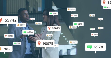 Image of notification icons with numbers, diverse coworkers discussing reports on digital tablet