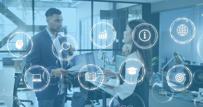 Image of icon in circles over diverse coworkers sharing ideas in office