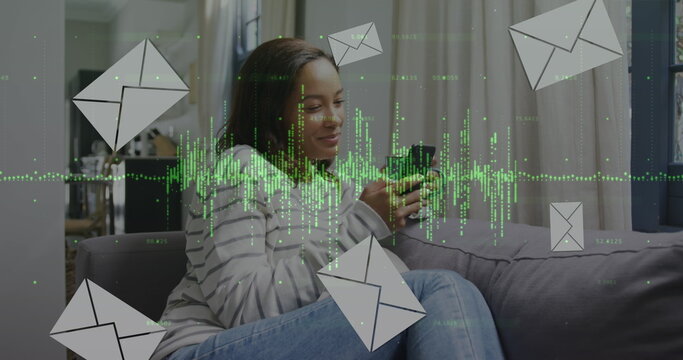 Image of data processing and envelopes icons over biracial woman using smartphone