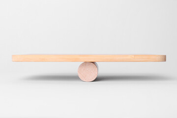 Equality concept. Wooden seesaw scale on light background