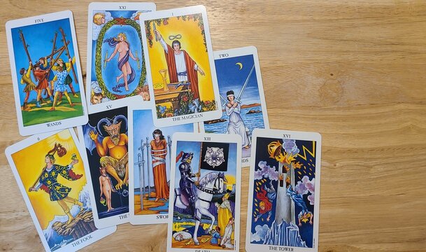various tarot cards on a light wooden table top, Radiant Rider-Wate Tarot deck