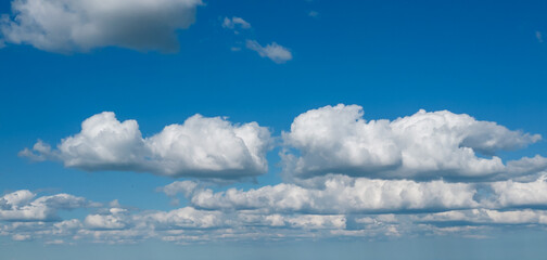 Poofy Clouds in a blue sky