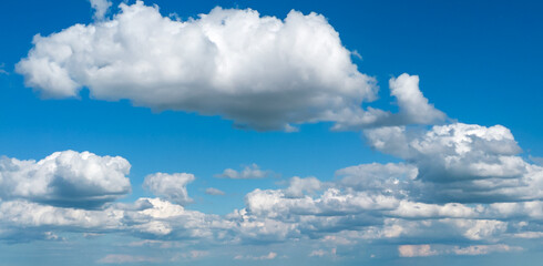Poofy Clouds in a blue sky
