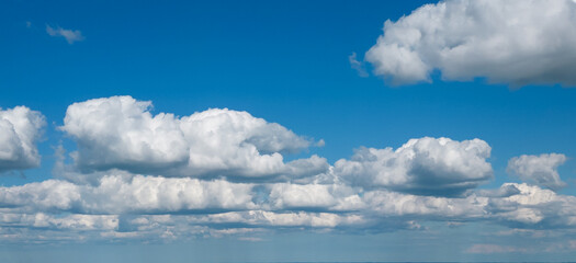 Poofy Clouds in a blue sky