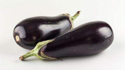 Two fresh eggplants on white background, close-up view. Healthy eating and organic food concept