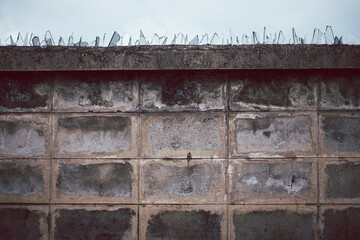 A wall with a fence on top of it