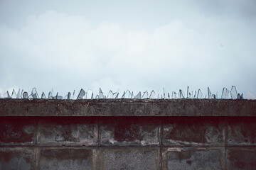 A wall with a lot of broken glass on it