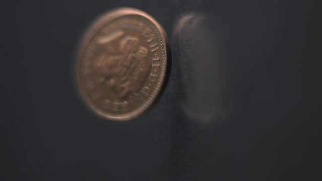 One Penny coin rotating slow motion, 0,01 &pound;, vertical view