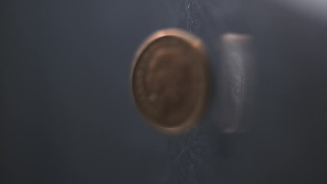 One Penny coin rotating slow motion, 0,01 &pound;, vertical view