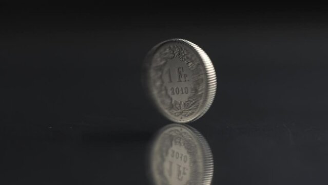 One Swiss Franc coin rotating slow motion, 1 CHF