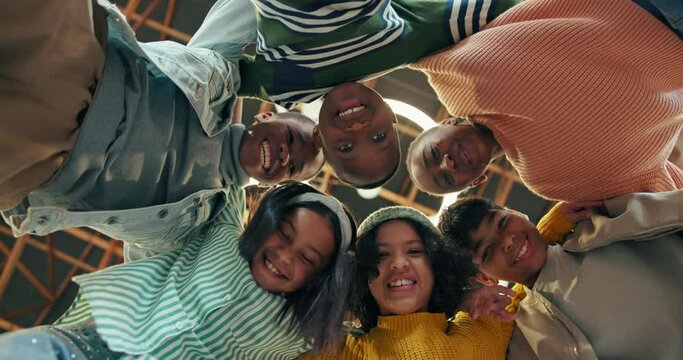 Group, young students and face in circle for solidarity, collaboration with diversity in youth community. Teamwork, friends and children or people together with happiness, below for support or trust