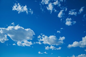 White fluffy clouds are slowly drifting on a deep blue sky