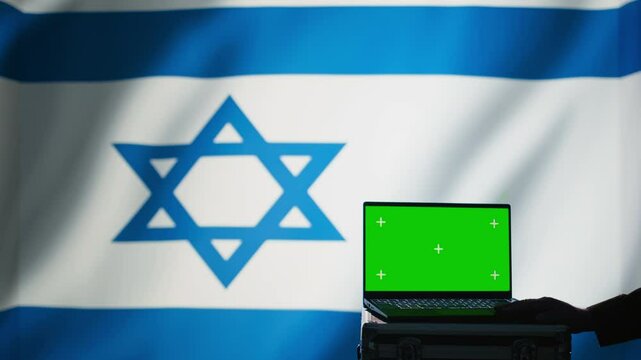Israel air defense command operator conscript using radar on green screen laptop to detect incoming missiles. IDF army soldier scanning rockets and deploying shields with mockup notebook, camera B