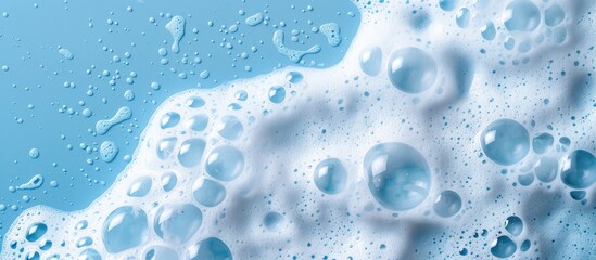 White foamy texture on a blue backdrop. Cleansing foam for face, bath bubbles, or laundry detergent. Macro shot with empty space.