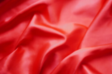 Texture red satin or silk is beautiful and luxurious (blurred)