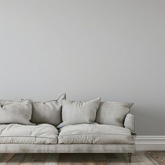 grey sofa in a room in front of empty wall